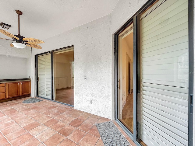 unfurnished living room with ceiling fan and tile patterned floors