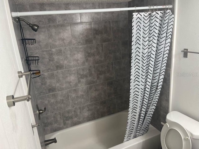 bathroom with shower / tub combo and toilet