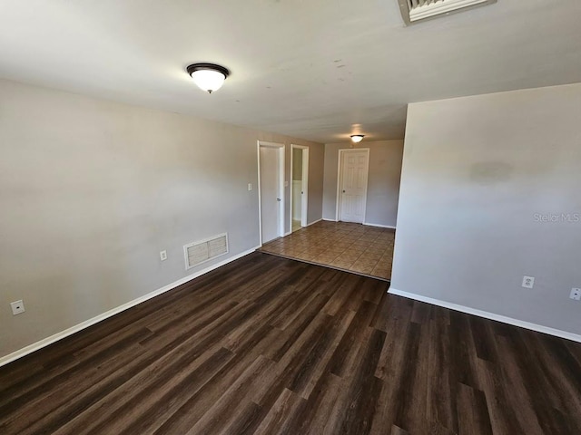 spare room with dark hardwood / wood-style floors