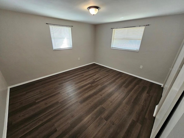 spare room featuring dark hardwood / wood-style flooring