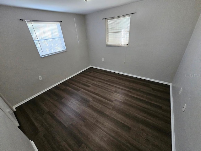 unfurnished room featuring dark hardwood / wood-style floors