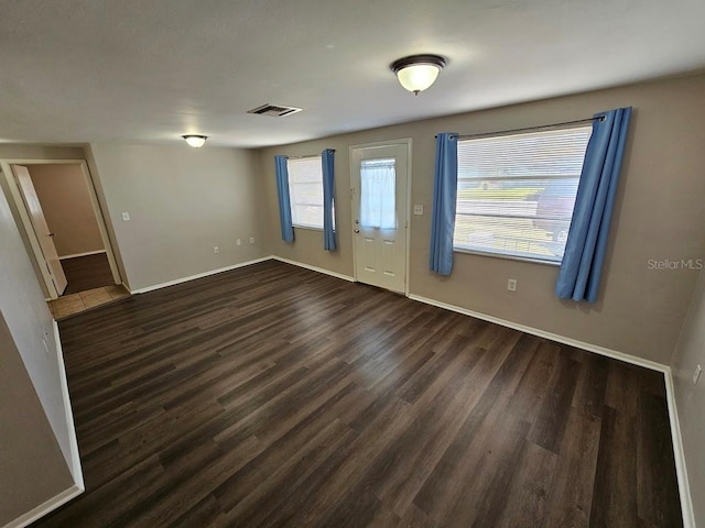 spare room with dark hardwood / wood-style flooring