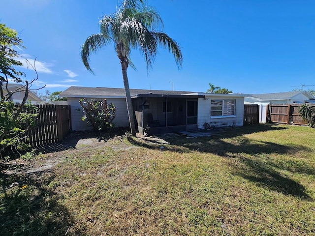 back of house with a lawn