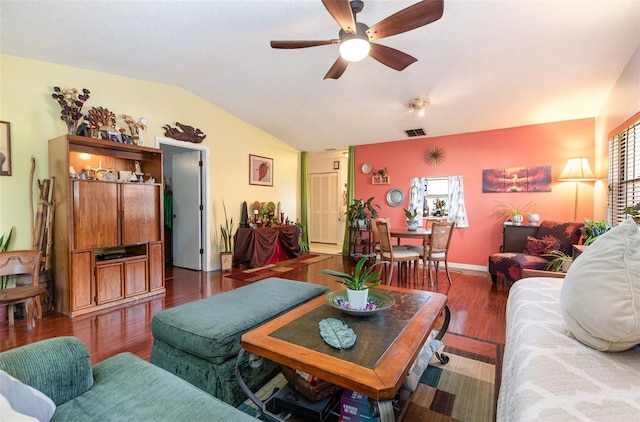 living room featuring vaulted ceiling, dark hardwood / wood-style flooring, and ceiling fan