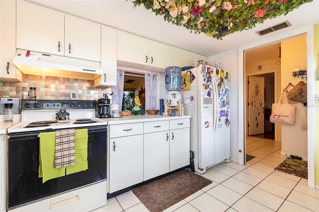 kitchen featuring white cabinets, light tile patterned floors, and white appliances