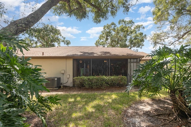 back of house with a sunroom, cooling unit, and a yard