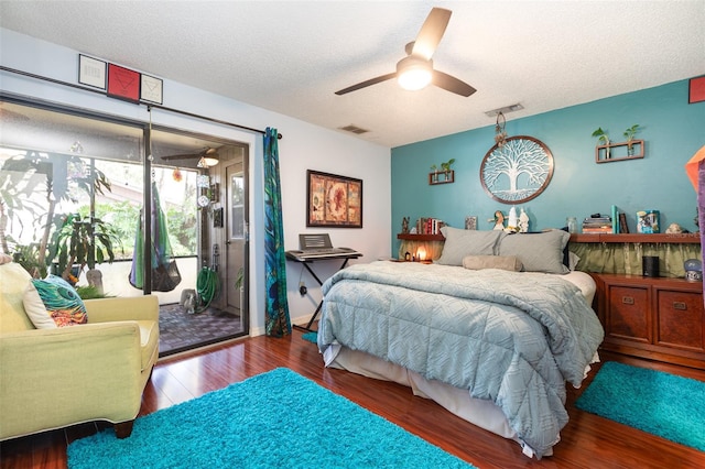 bedroom with a textured ceiling, hardwood / wood-style flooring, ceiling fan, and access to exterior