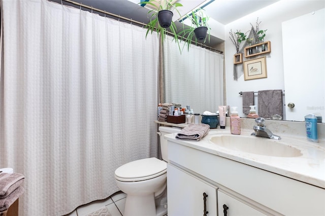 bathroom with tile patterned flooring, vanity, and toilet