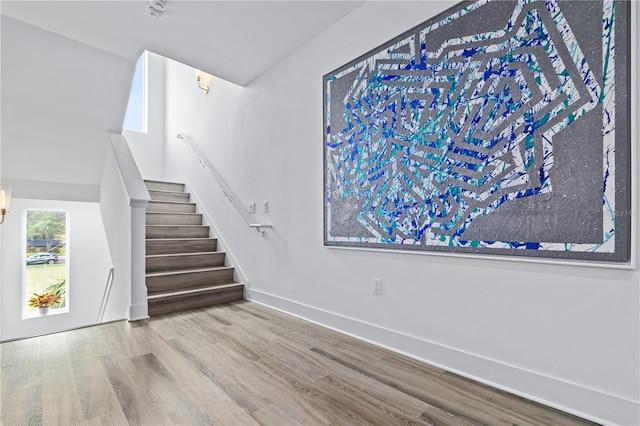 stairs with hardwood / wood-style flooring