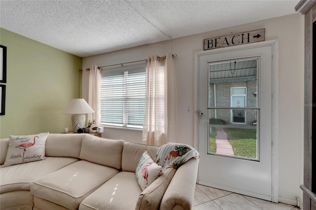 tiled living room featuring a textured ceiling