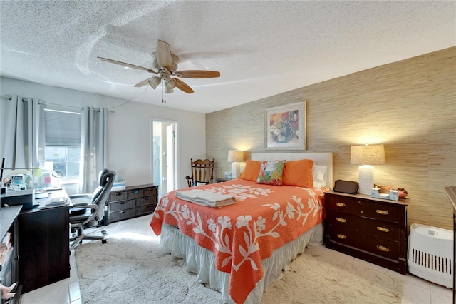 bedroom featuring ceiling fan, a textured ceiling, and light carpet