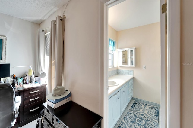 bathroom featuring a textured ceiling, vanity, and tile patterned floors