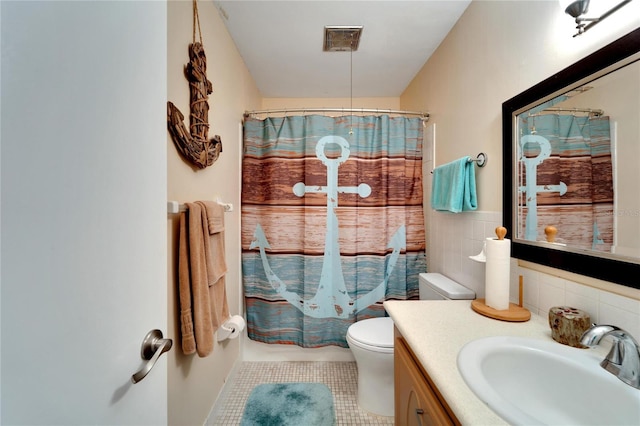 bathroom with backsplash, vanity, toilet, and tile patterned floors