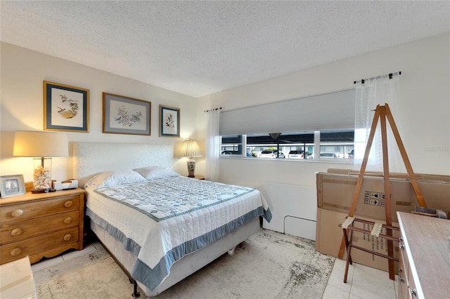 tiled bedroom featuring a textured ceiling