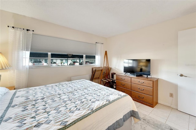 bedroom with light tile patterned flooring and multiple windows