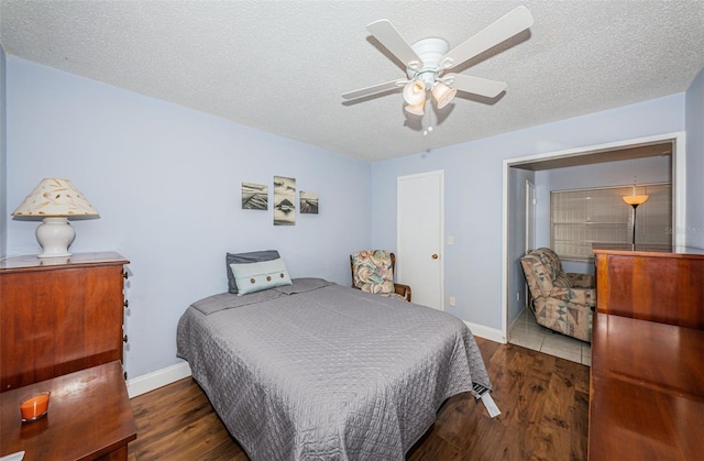 bedroom featuring a textured ceiling, ceiling fan, and dark hardwood / wood-style flooring