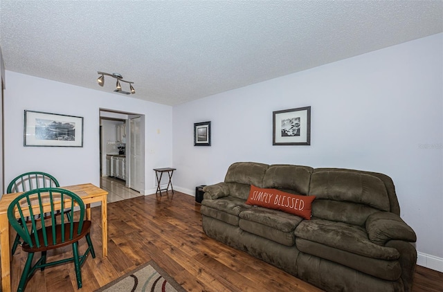 living room with a textured ceiling and hardwood / wood-style flooring