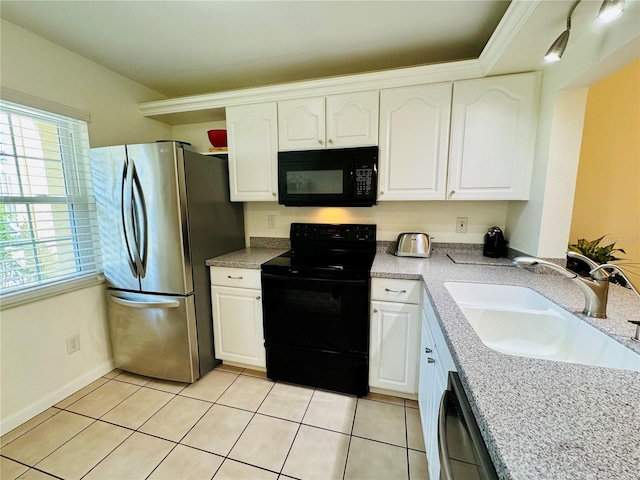 kitchen featuring black appliances, white cabinetry, light tile patterned flooring, and sink