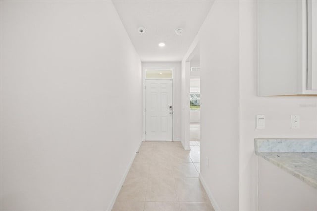 hall with light tile patterned flooring