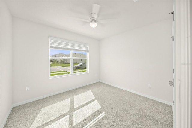 empty room with light colored carpet and ceiling fan