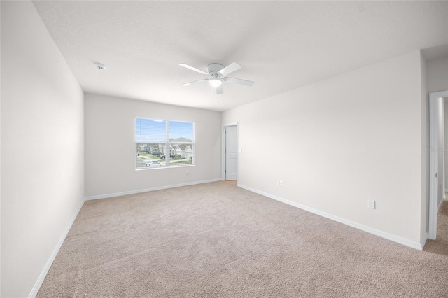 unfurnished room featuring ceiling fan and light colored carpet