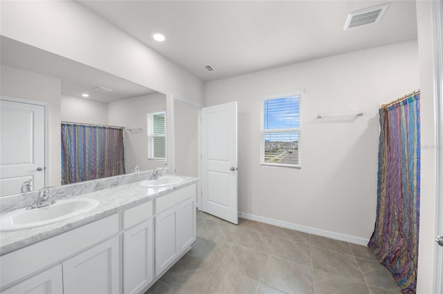 bathroom featuring a shower with curtain, a wealth of natural light, vanity, and tile patterned floors