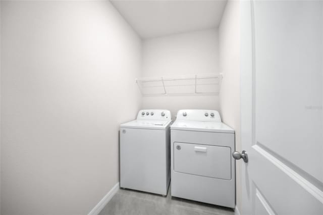 clothes washing area with washing machine and dryer