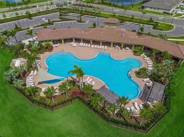 view of pool with a lawn and a patio