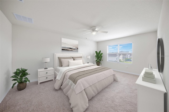 bedroom featuring ceiling fan and light carpet