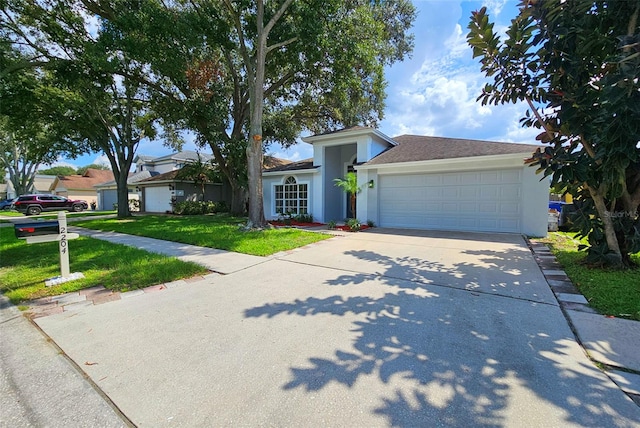 view of front of property with a front yard and a garage