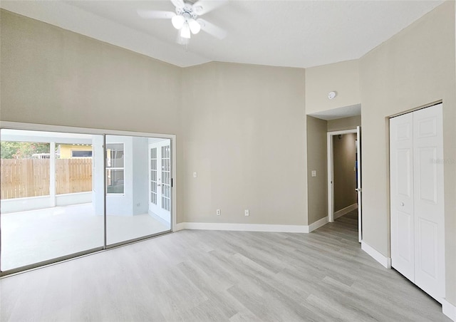 unfurnished bedroom featuring ceiling fan, a closet, access to outside, and light hardwood / wood-style flooring