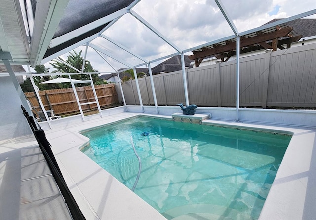 view of swimming pool with glass enclosure and a patio area