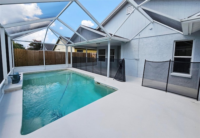 view of swimming pool with a lanai and a patio area