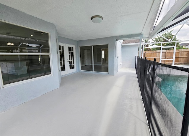 view of patio / terrace with french doors and a lanai