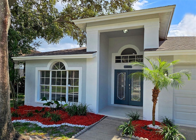 doorway to property with a garage