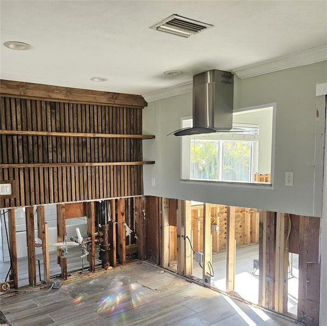 interior space with crown molding and hardwood / wood-style flooring