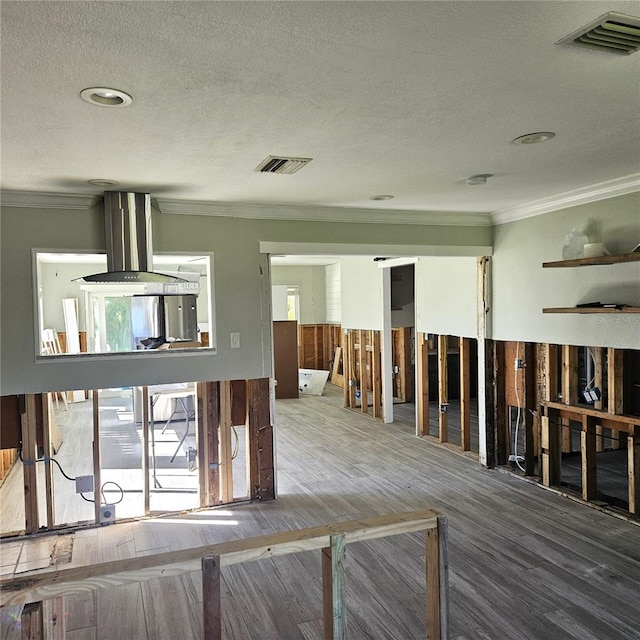 misc room featuring hardwood / wood-style flooring, a textured ceiling, and ornamental molding