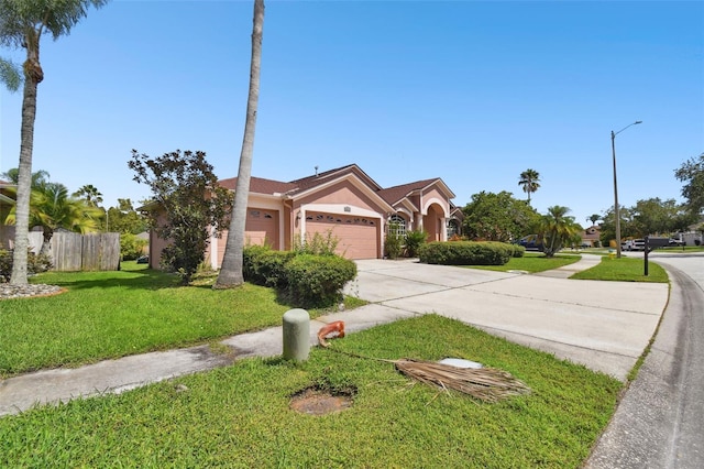 view of front of property featuring a front lawn and a garage