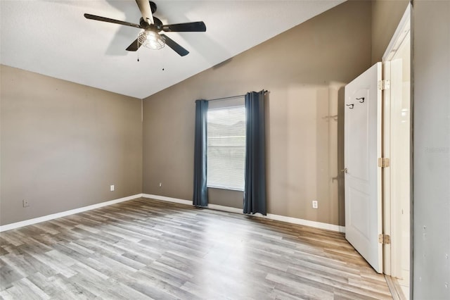 unfurnished bedroom with light wood-type flooring, lofted ceiling, and ceiling fan