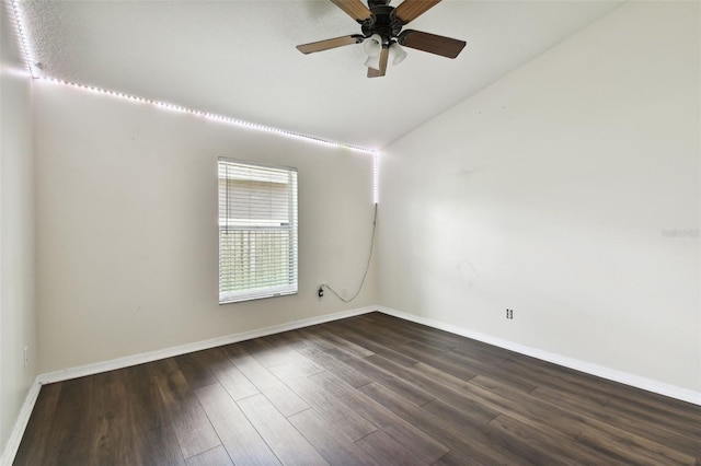 empty room featuring vaulted ceiling, ceiling fan, and dark hardwood / wood-style flooring