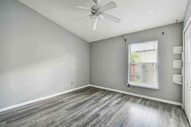 empty room featuring ceiling fan and hardwood / wood-style floors