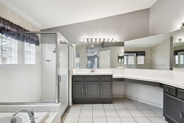 bathroom with vanity, lofted ceiling, shower with separate bathtub, and a healthy amount of sunlight