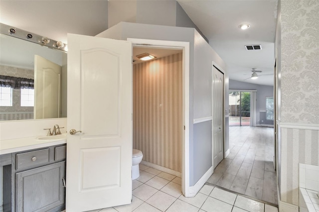 bathroom featuring wood-type flooring, vanity, toilet, and ceiling fan