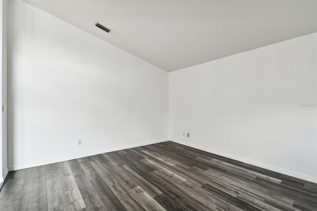 spare room with dark wood-type flooring