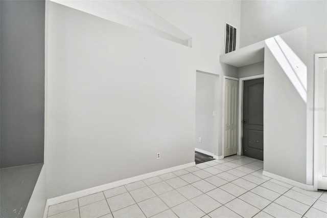 unfurnished bedroom with a closet and light tile patterned floors