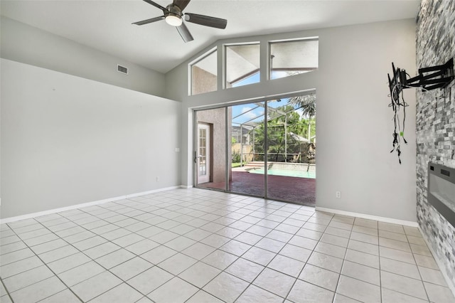 tiled spare room with lofted ceiling and ceiling fan