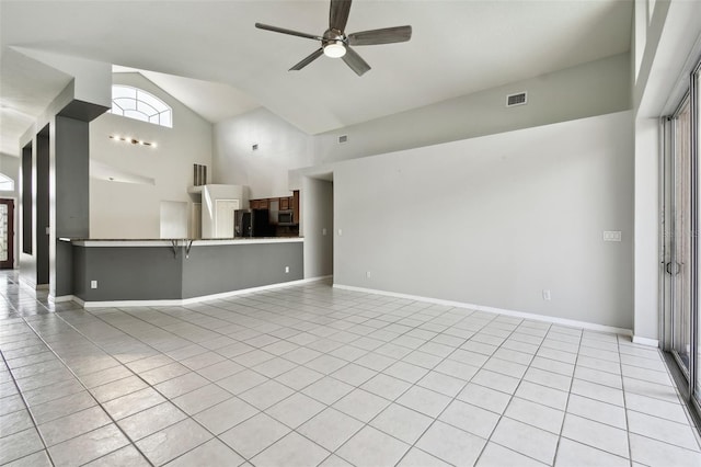 interior space featuring high vaulted ceiling and ceiling fan