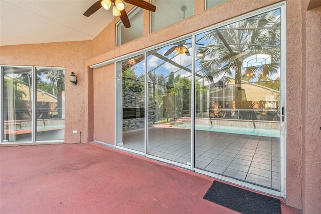 exterior space with ceiling fan and vaulted ceiling