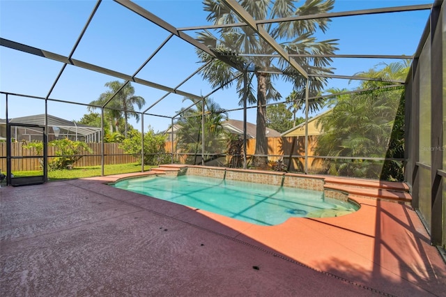 view of pool with a patio and glass enclosure