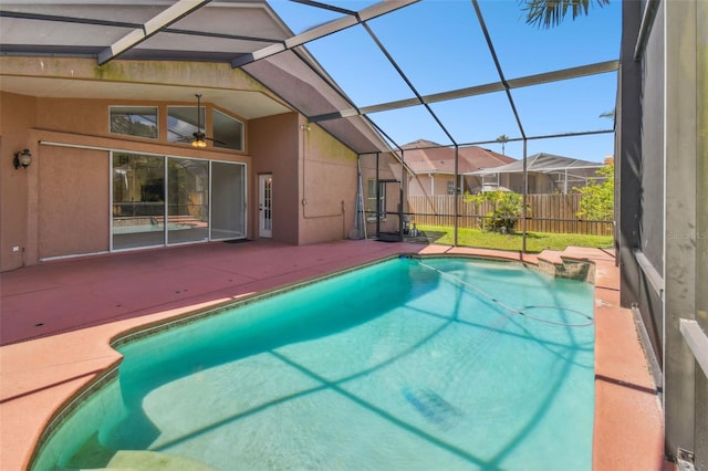 view of swimming pool with a lanai and a patio